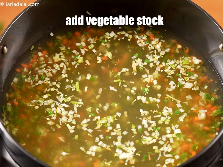 Step 16 – Add 4 cups <a href="https://www.tarladalal.com/clear-vegetable-stock-4181r" target="_blank">vegetable stock</a>.