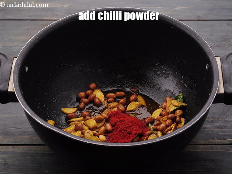 Step 12 – Switch off the flame, add the <a href="https://www.tarladalal.com/glossary-chilli-powder-red-chilli-powder-339i" target="_blank">chilli powder</a>.