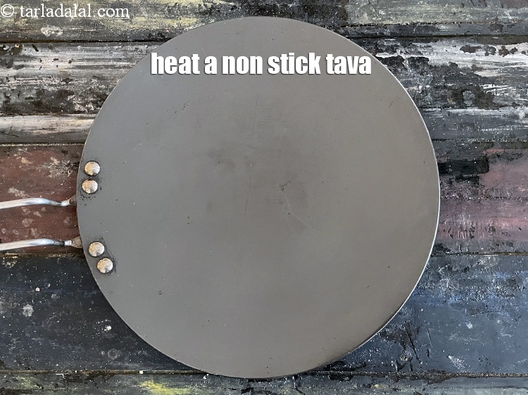 Step 13 – <meta charset="UTF-8" />Heat a non-stick tava (griddle).