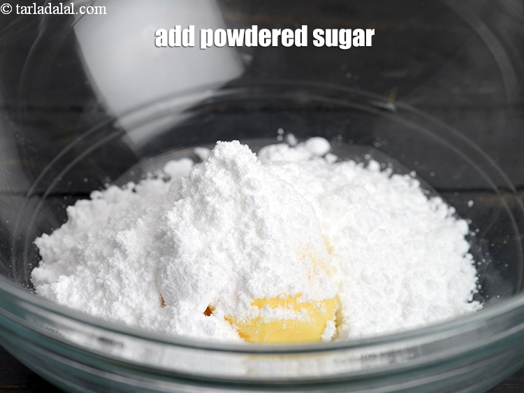 Step 12 – Add &frac12; cup&nbsp;<a href="https://www.tarladalal.com/glossary-powdered-sugar-280i">powdered sugar</a>.