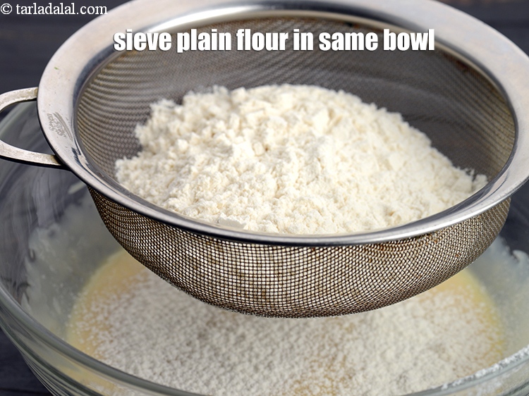 Step 14 – Sieve 3/4 cup <a href="https://www.tarladalal.com/glossary-plain-flour-maida-188i">plain flour (maida)</a> in the same bowl.