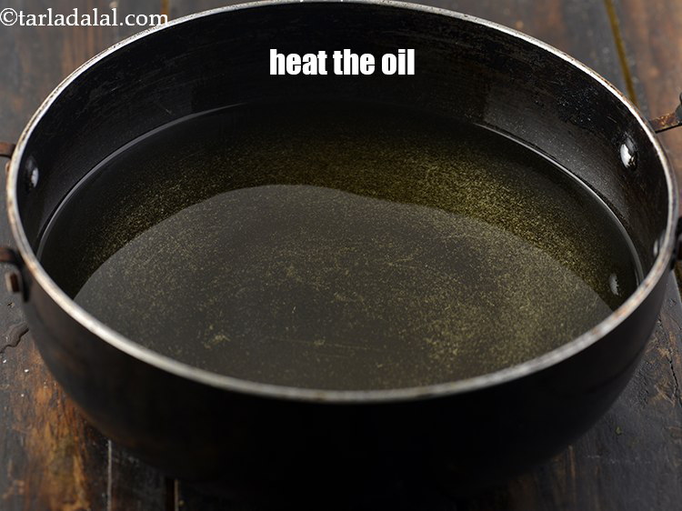 Step 44 – Heat the <a href="https://www.tarladalal.com/glossary-oil-671i" target="_blank">oil</a> in a deep non-stick pan.