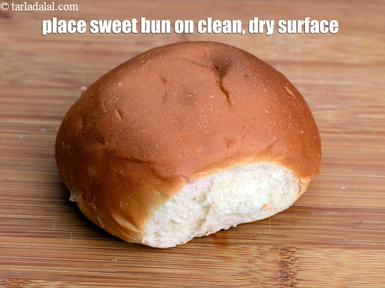 Step 12 – Place a <a href="https://www.tarladalal.com/sweet-buns-1844r">sweet bun</a>&nbsp;on a clean, dry surface.