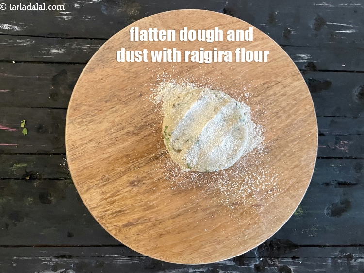 Step 12 – Flatten dough and dust with rajgira flour.