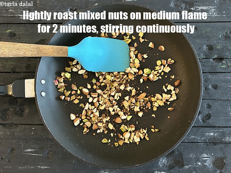 Step 12 – Lightly roast mixed nuts on medium flame for 2&nbsp;minutes, stirring continuously.