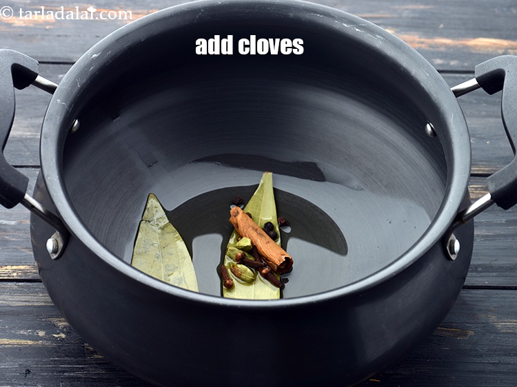 Step 13 – Add 4&nbsp;<a href="https://www.tarladalal.com/glossary-cloves-laung-lavang-322i">cloves (laung / lavang)</a>.&nbsp;
