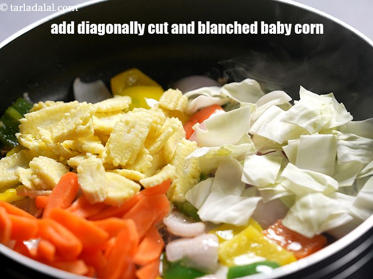 Step 20 – Add 1/2 cup&nbsp;<a href="https://www.tarladalal.com/glossary-diagonally-cut-and-blanched-baby-corn-2308i">diagonally cut and blanched baby corn</a>.&nbsp;