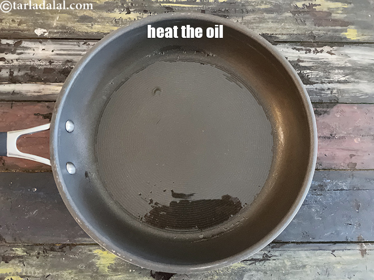 Step 12 – Heat the oil in a wok or a deep- non-stick kadhai on a high flame.