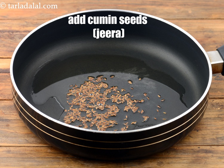 Step 13 – Once the oil is hot, add the <a href="https://www.tarladalal.com/glossary-cumin-seeds-jeera-zeera-381i">cumin seeds (jeera)</a>.