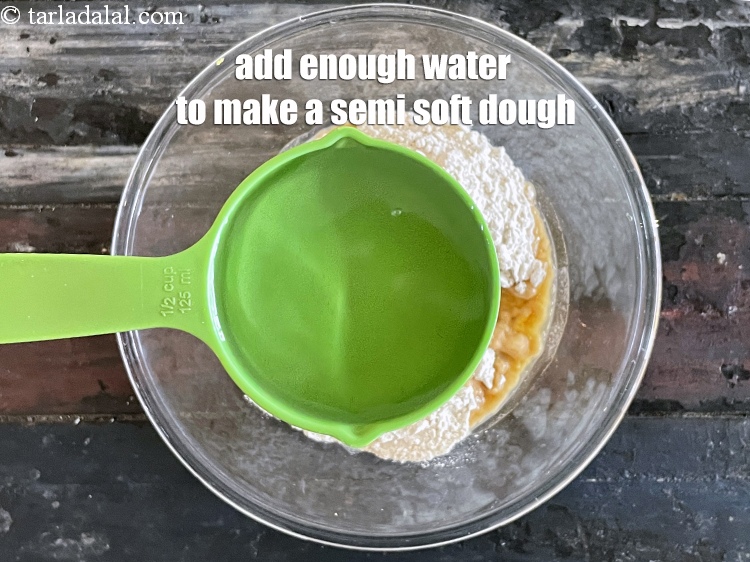 स्टेप 12 – पर्याप्त पानी डालकर एक अर्ध-नरम आटा तैयार करें। हमने 1/2 …