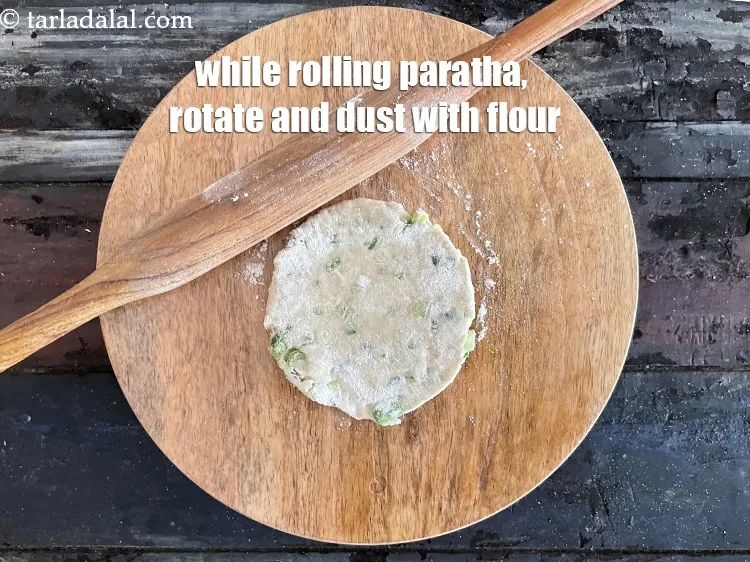 Step 15 – While rolling the paratha, rotate and dust with flour.