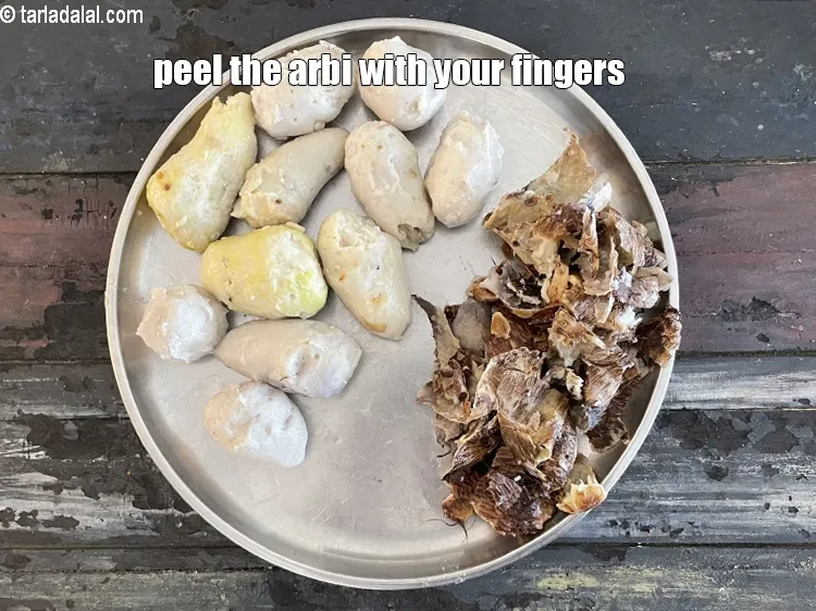 Step 22 – Peel the arbi (colocasia) with your fingers.