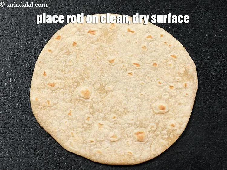 Step 12 – To make &lt;strong&gt;aloo taco on tava,&lt;/strong&gt; place a &lt;a href=&quot;https://www.tarladalal.com/rotis-38565r&quot;&gt;roti&lt;/a&gt;&amp;nbsp;on a clean, dry surface.