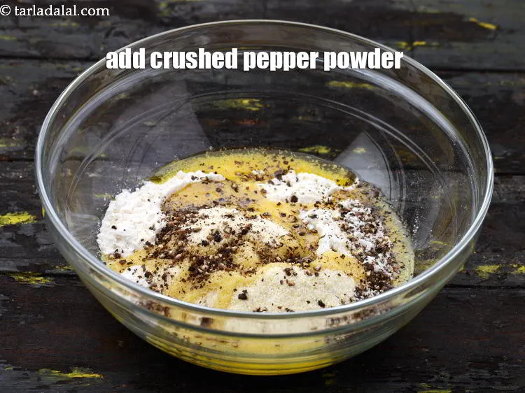 Step 14 – Add the coarsely <a href="https://www.tarladalal.com/glossary-crushed-black-pepper-568i" target="_blank">crushed pepper powder</a>. See above how to make pepper powder.