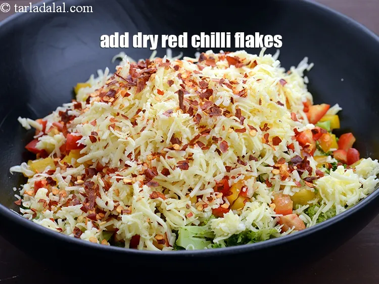 Step 13 – Add 1 tbsp <a href="https://www.tarladalal.com/glossary-dry-red-chilli-flakes-paprika-338i">dry red chilli flakes (paprika)</a>.