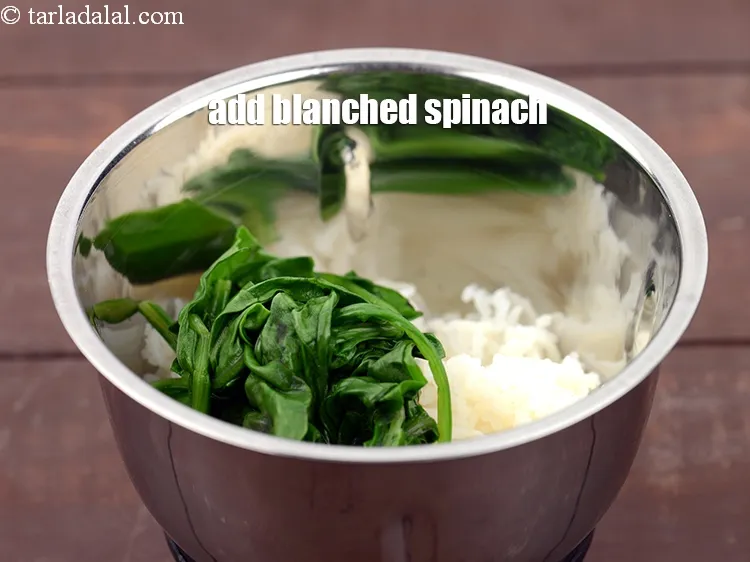 Step 12 – Add &frac14; cup <a href="https://www.tarladalal.com/glossary-blanched-spinach-727i">blanched spinach (palak)</a>.