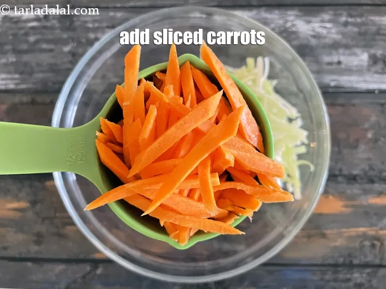Step 14 – Add 1/2 cup&nbsp;<a href="https://www.tarladalal.com/glossary-carrot-juliennes-754i">carrot juliennes</a>.