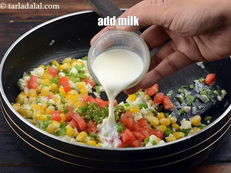 Step 12 – Add 2 tbsp&nbsp;<a href="https://www.tarladalal.com/glossary-milk-doodh-full-cream-milk-514i">milk</a>.&nbsp;