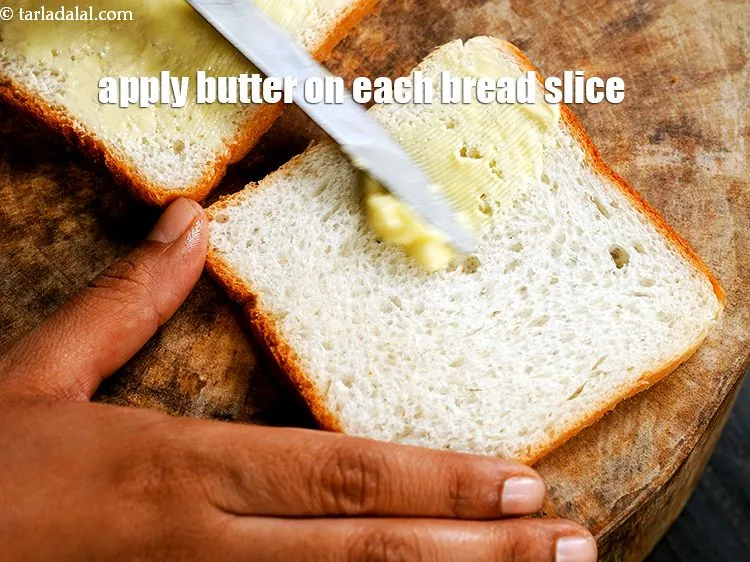 Step 14 – Apply &frac12; tsp of <a href="https://www.tarladalal.com/glossary-butter-makhan-233i">butter</a>&nbsp;on each bread slice.&nbsp;