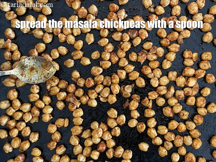 Step 23 – Put the chickpeas on a baking tray and spread with a spoon.