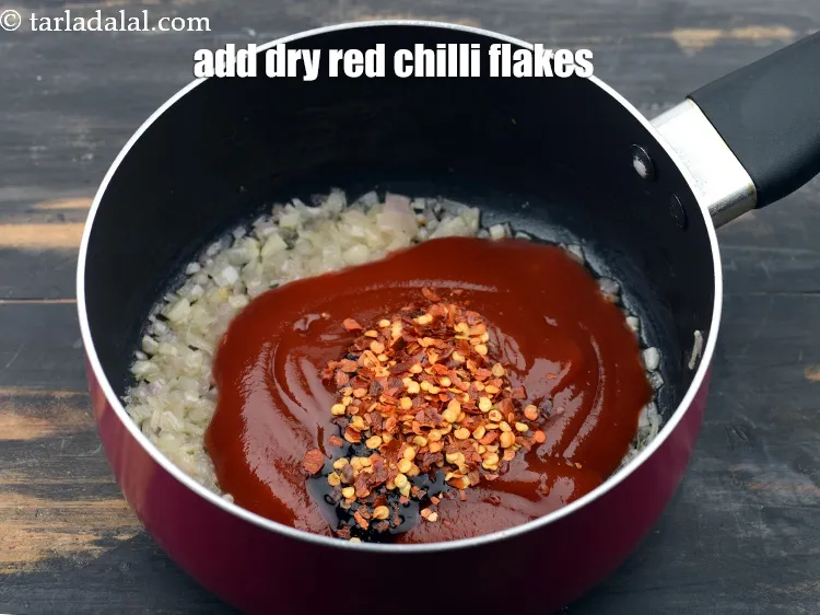 Step 13 – Add 1/2 tbsp&nbsp;<a href="https://www.tarladalal.com/glossary-dry-red-chilli-flakes-paprika-338i">dry red chilli flakes (paprika)</a>.