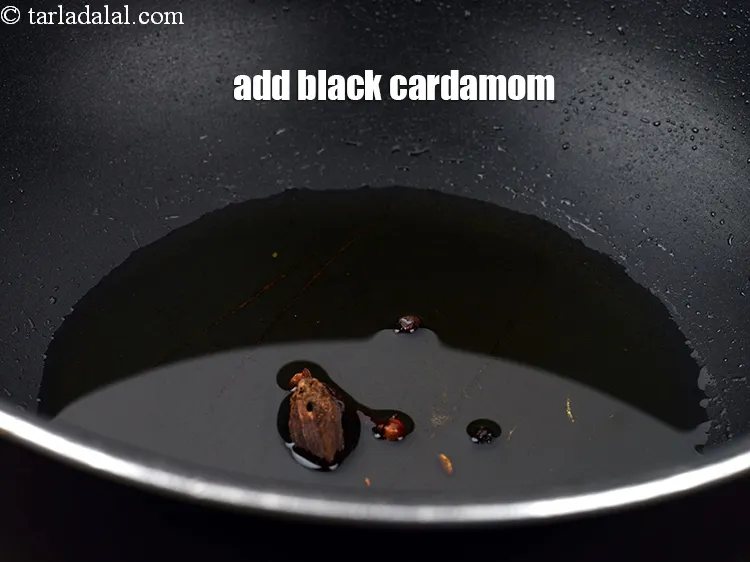 Step 13 – Add 1 <a href="https://www.tarladalal.com/glossary-black-cardamom-badi-elaichi-moti-elaichi-263i">black cardamom (badi elaichi)</a>.