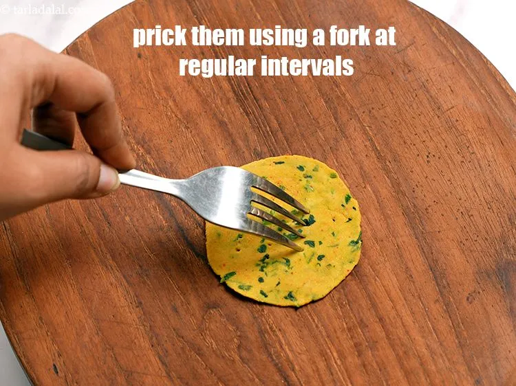 Step 13 – Prick them using a fork at regular intervals. Repeat steps to make remaining&nbsp;puris.