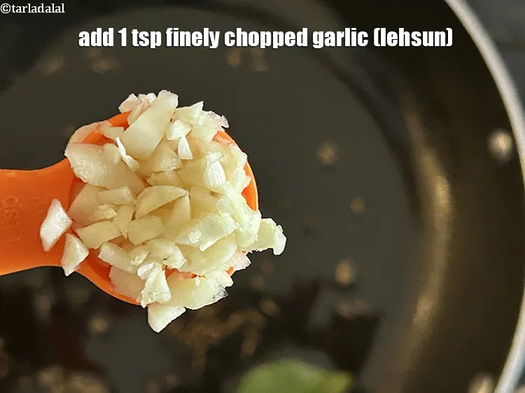 Step 20 – Add&nbsp;<meta charset="UTF-8" />1 tsp&nbsp;finely&nbsp;<a href="glossary-chopped-garlic-790i">chopped garlic (lehsun)</a>.