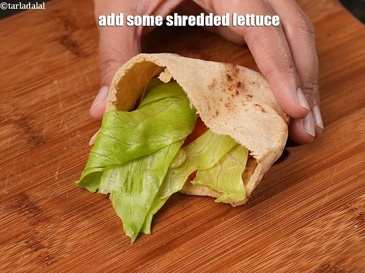 Step 33 – Add some&nbsp;<a href="https://www.tarladalal.com/glossary-shredded-lettuce-856i">shredded lettuce</a>.
