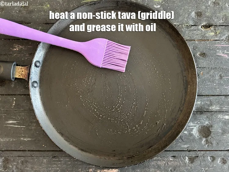 Step 13 – Heat a non-stick tava (griddle) and grease it with oil. &nbsp; &nbsp;