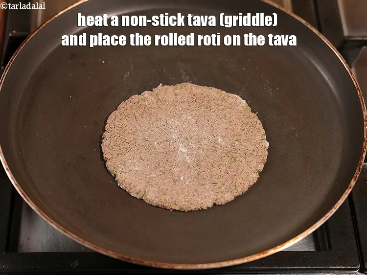 Step 13 – Heat a non-stick tava (griddle) and place the rolled roti on the tava.