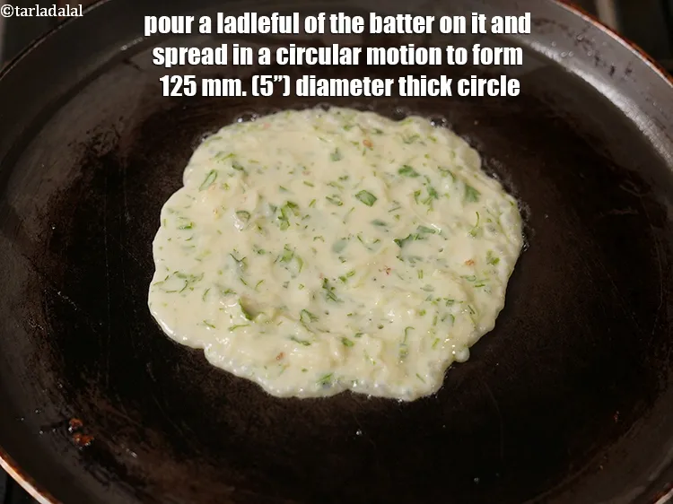 Step 13 – Pour a ladleful of the batter on it and spread in a circular motion to …