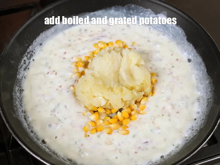 Step 13 – Add &frac12; cup <a href="https://www.tarladalal.com/glossary-boiled-peeled-and-grated-potatoes-2341i">boiled peeled and grated potatoes</a>.