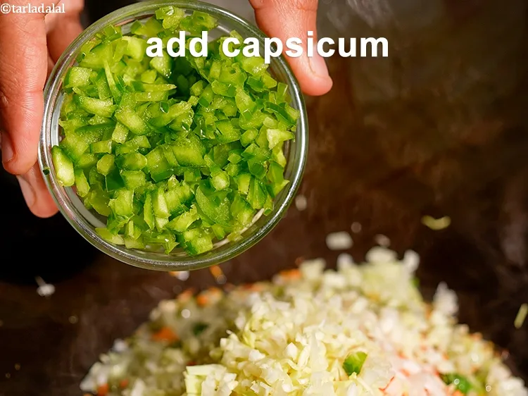Step 16 – Add &frac14; cup finely <a href="https://www.tarladalal.com/glossary-chopped-capsicum-164i">chopped capsicum</a>.