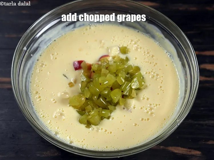 Step 13 – Add &frac12; cup&nbsp;<a href="https://www.tarladalal.com/glossary-chopped-grapes-1070i">chopped grapes</a>.