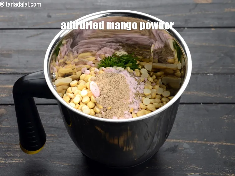 Step 13 – Add 1 tsp <a href="https://www.tarladalal.com/glossary-dried-mango-powder-amchur-powder-148i">dried mango powder (amchur)</a>.