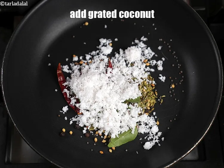 Step 13 – Add &frac14; cup <a href="https://www.tarladalal.com/glossary-grated-coconut-852i">grated coconut</a>.