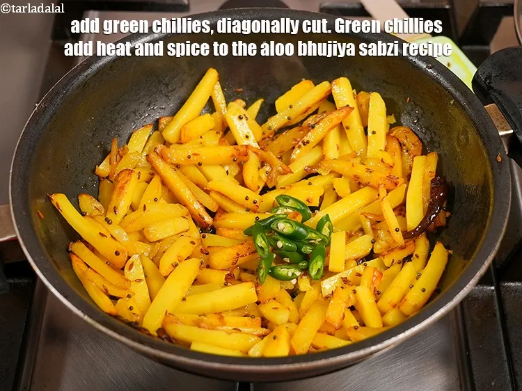 Step 13 – Add 2 <a href="https://www.tarladalal.com/glossary-green-chillies-hari-mirch-331i">green chillies</a>, diagonally cut. Green chillies add heat and spice to the …