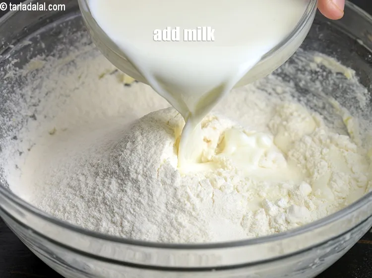 Step 15 – Add &frac12; cup <a href="https://www.tarladalal.com/glossary-milk-doodh-full-cream-milk-514i">milk</a>.