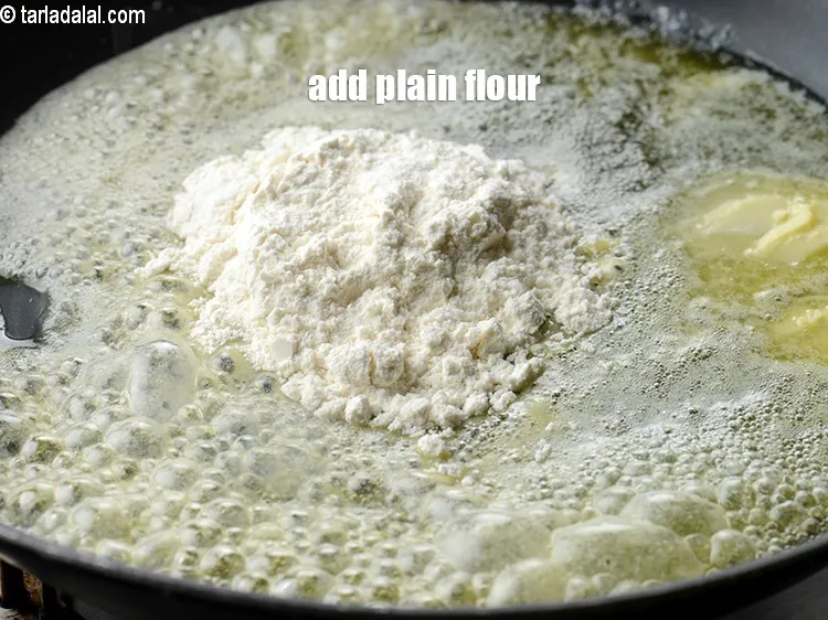 Step 14 – Add 2 tbsp <a href="https://www.tarladalal.com/glossary-plain-flour-maida-188i">plain flour (maida)</a>.