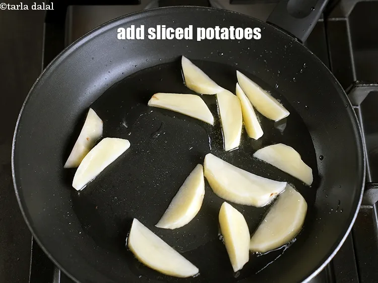 Step 13 – Add &frac34; cup <a href="https://www.tarladalal.com/glossary-sliced-potatoes-761i">sliced potatoes</a>.