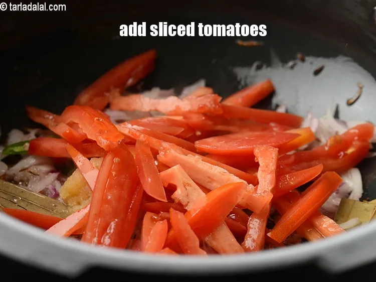Step 13 – Add &frac12; cup <a href="https://www.tarladalal.com/glossary-sliced-tomatoes-746i">sliced tomatoes</a>.