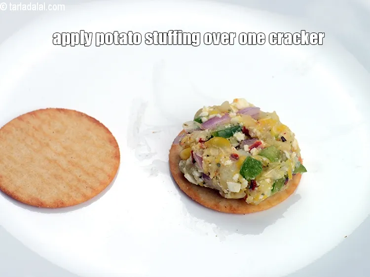 Step 13 – Apply 1&frac12; tsp of potato stuffing over one cracker.&nbsp;