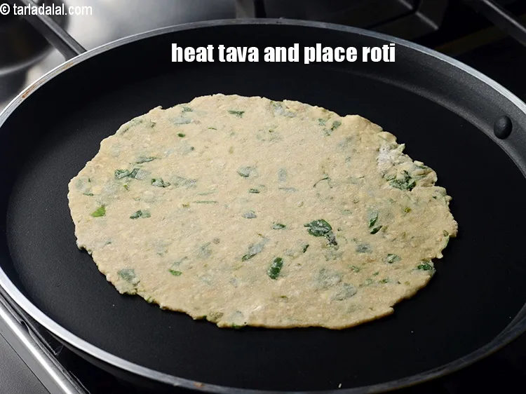 Step 13 – Heat a non-stick tava (griddle) and place the roti.