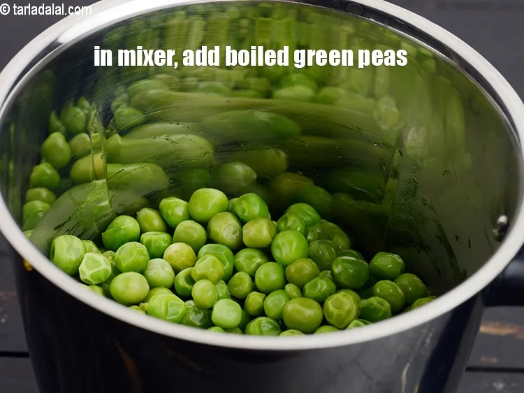 Step 14 – In a mixer, add 1 &frac12; cups boiled fresh <a href="https://www.tarladalal.com/glossary-green-peas-matar-hare-matar-vatana-180i">green peas</a>.