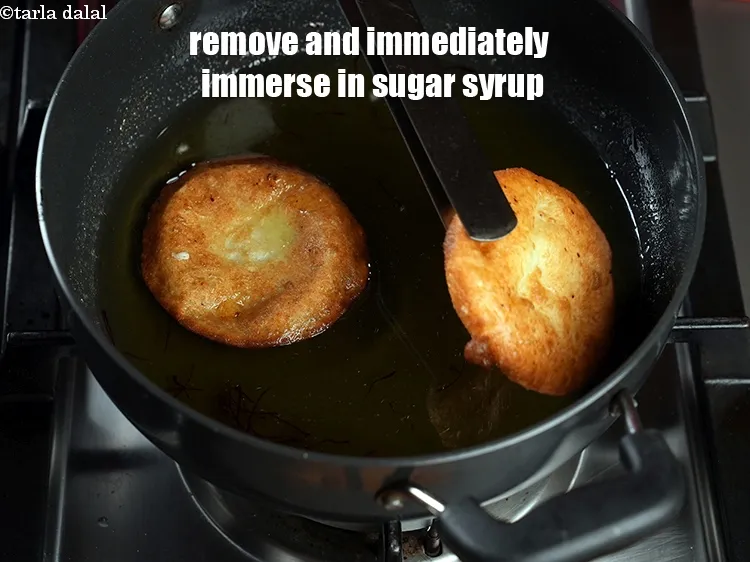 Step 25 – Remove the malpua and immediately immerse it in the sugar syrup.