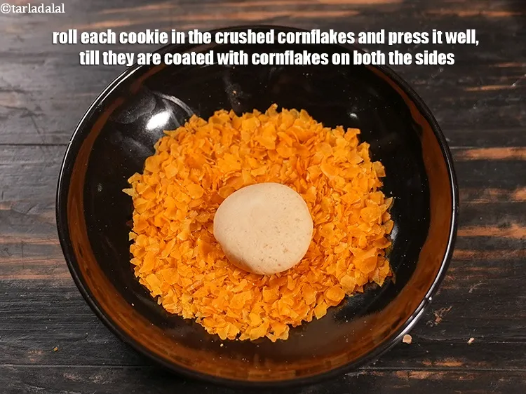 Step 13 – Roll each cookie in the crushed cornflakes and press it well, till they are coated …