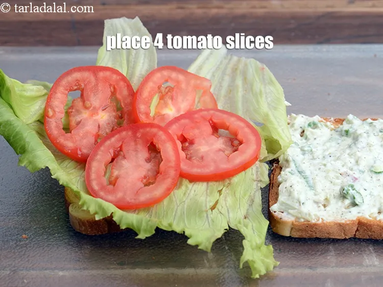 Step 13 – Place 4 <a href="https://tarladalal.com/glossary-tomato-slices-1823i">tomato slices</a>.