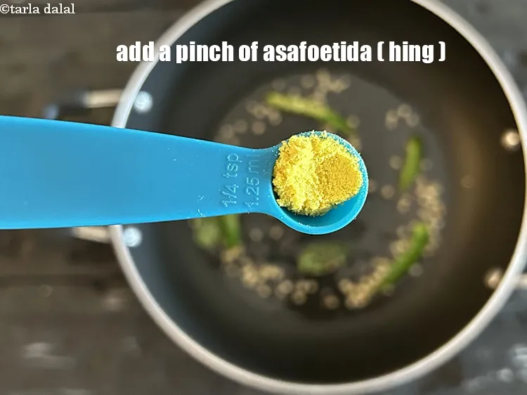 Step 19 – <html><head></head><body><p>Add&nbsp;a pinch of&nbsp;<a href="glossary-asafoetida-hing-113i">asafoetida (hing)</a>.</p></body></html>