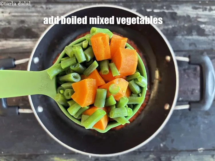 Step 14 – Add&nbsp;<meta charset="UTF-8" />1 cup&nbsp;<a href="glossary-boiled--mixed-vegetables-1018i">boiled mixed vegetables</a>&nbsp;(french beans and carrot) cubes.